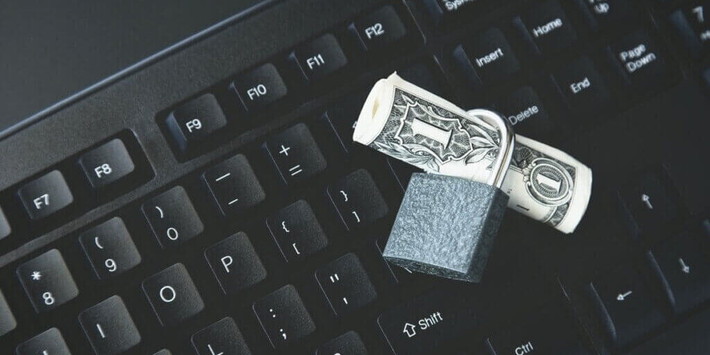 high-angle-shot-lock-around-dollar-bill-black-laptop