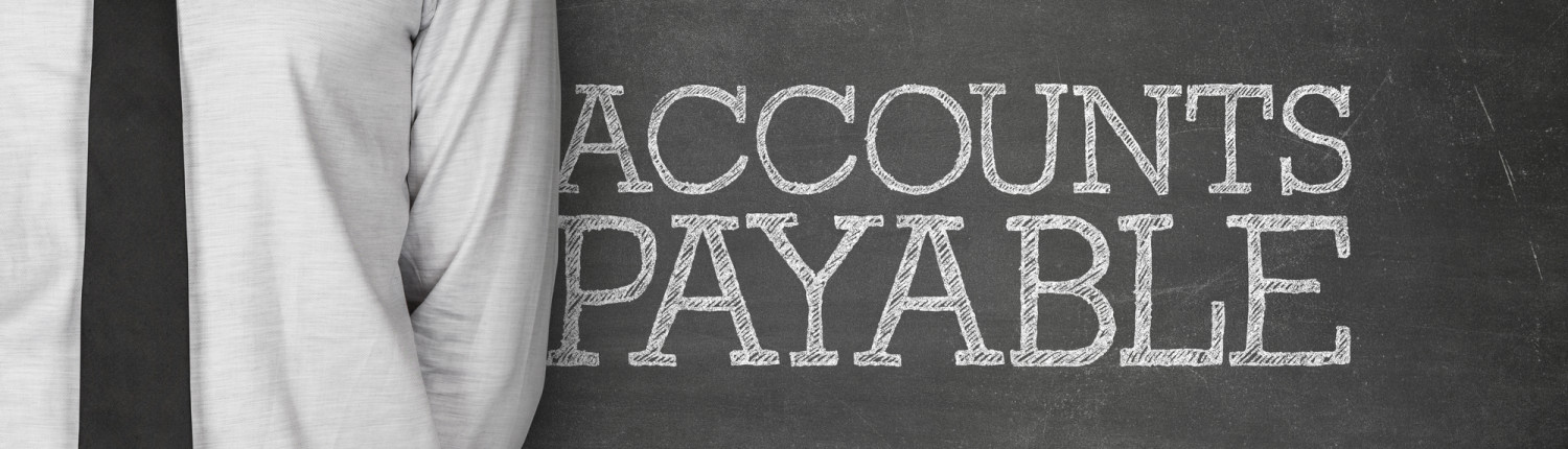 Accounts payable text on blackboard with businessman on side