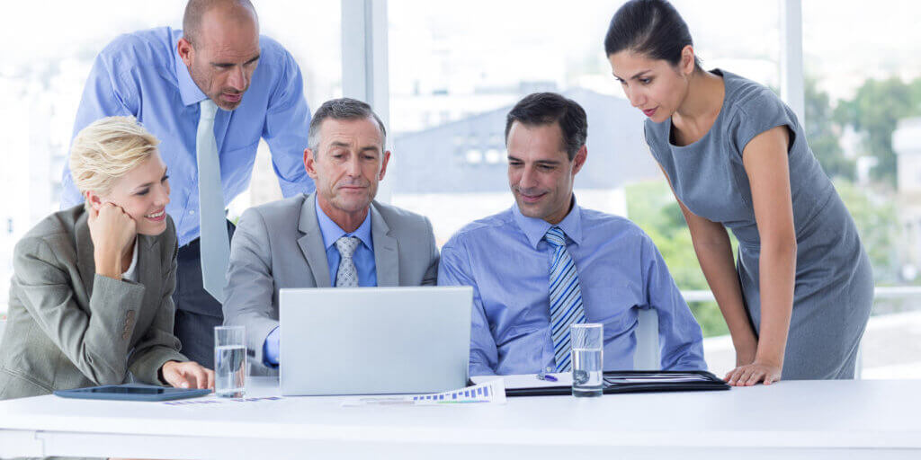 Business team working together on laptop in the office