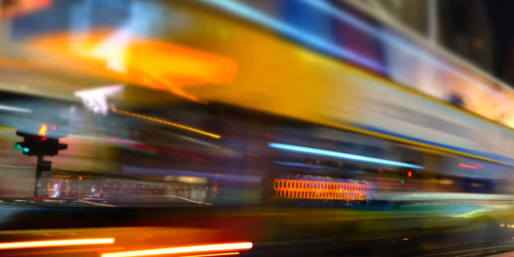 Abstract cityscape blurred background. ight view of modern city street with moving transport and illuminated skyscrapers. Hong Kong