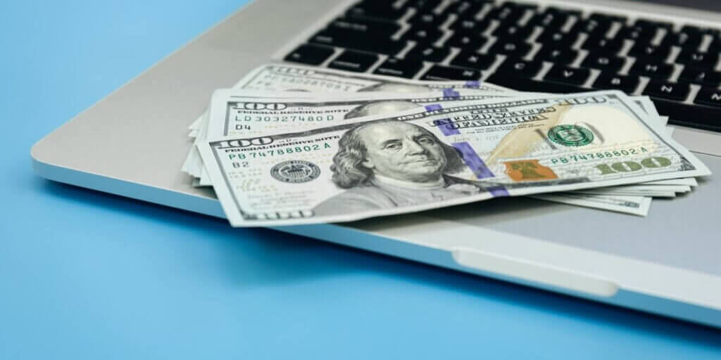 close-up-dollar-bills-laptop-money-making-concept