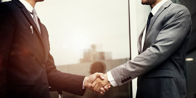 Corporate businessmen shaking hands