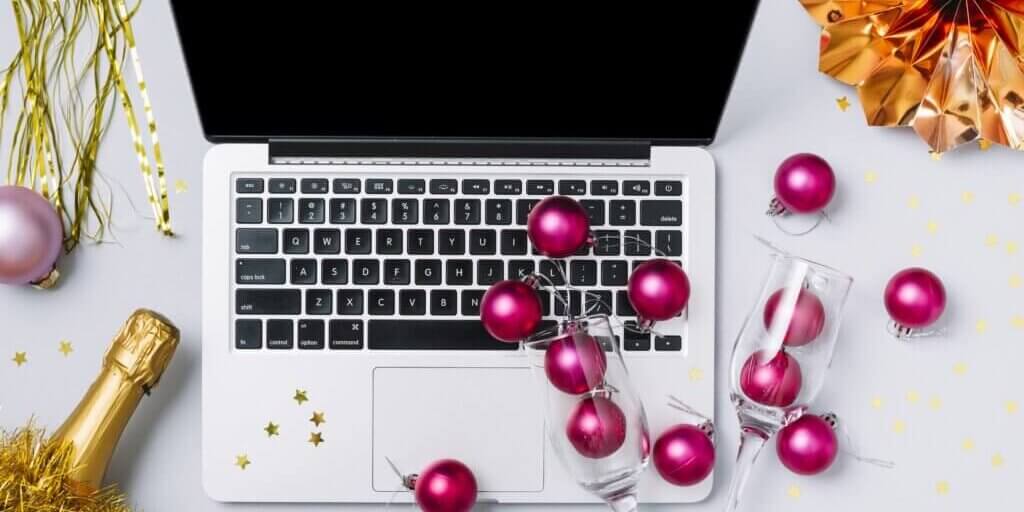 laptop-with-champagne-bottle-white-table