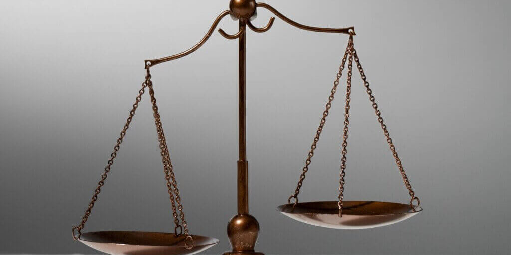 still<a href="https://www.magnific.com/free-photo/still-life-with-scales-justice_33123976.htm">Image by magnific</a>-life-with-scales-justice cropped