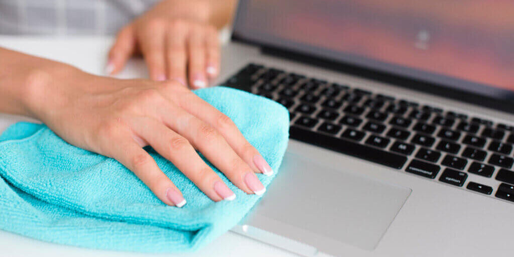 woman-hand-cleaning-laptop-home