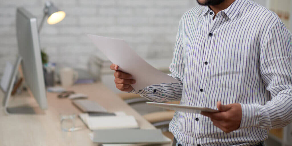 Cropped image of young bsuiness executive checking contract
